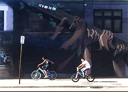bicyclists pasing by the mural